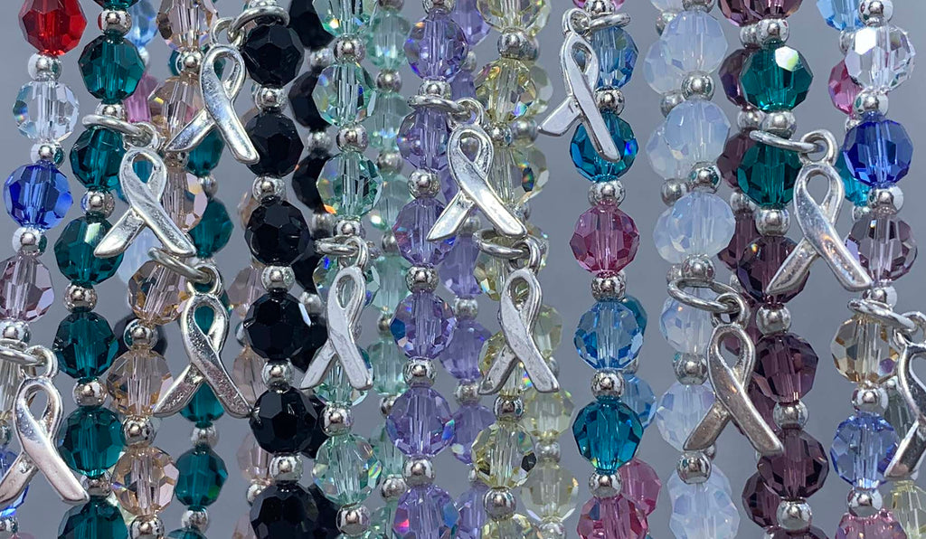 Cancer awareness bracelets in multiple crystal colors representing different cancer ribbon colors