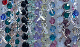Cancer awareness bracelets in multiple crystal colors representing different cancer ribbon colors
